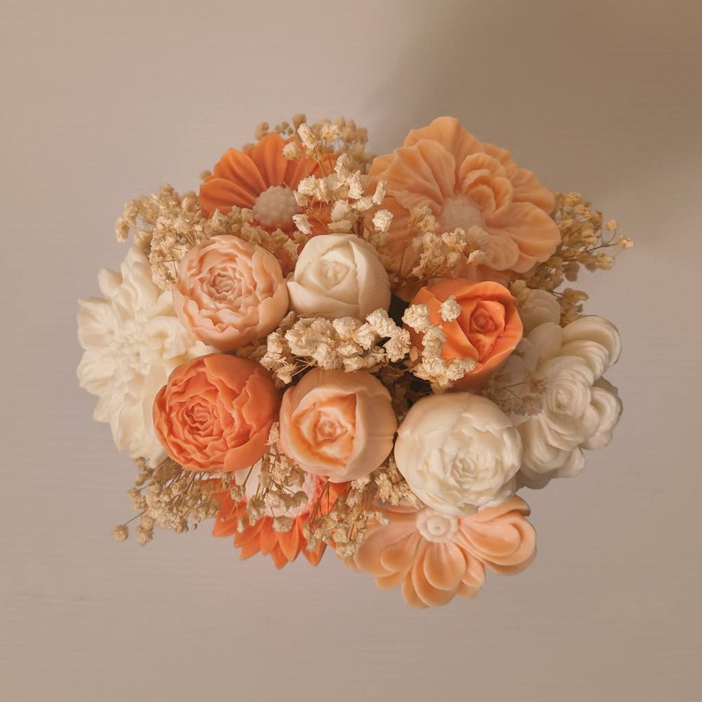 A decorative bouquet of artificial flowers in peach, orange, and cream tones, including roses, daisies, and baby's breath, arranged against a soft beige background.