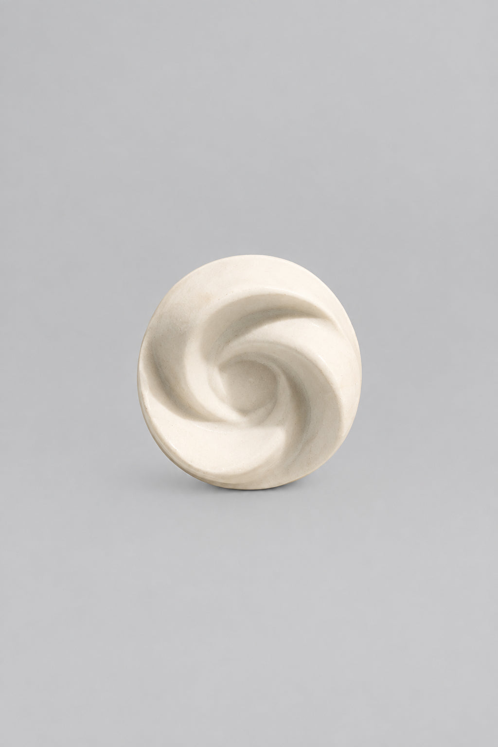 A small off-white spiral-shaped object.